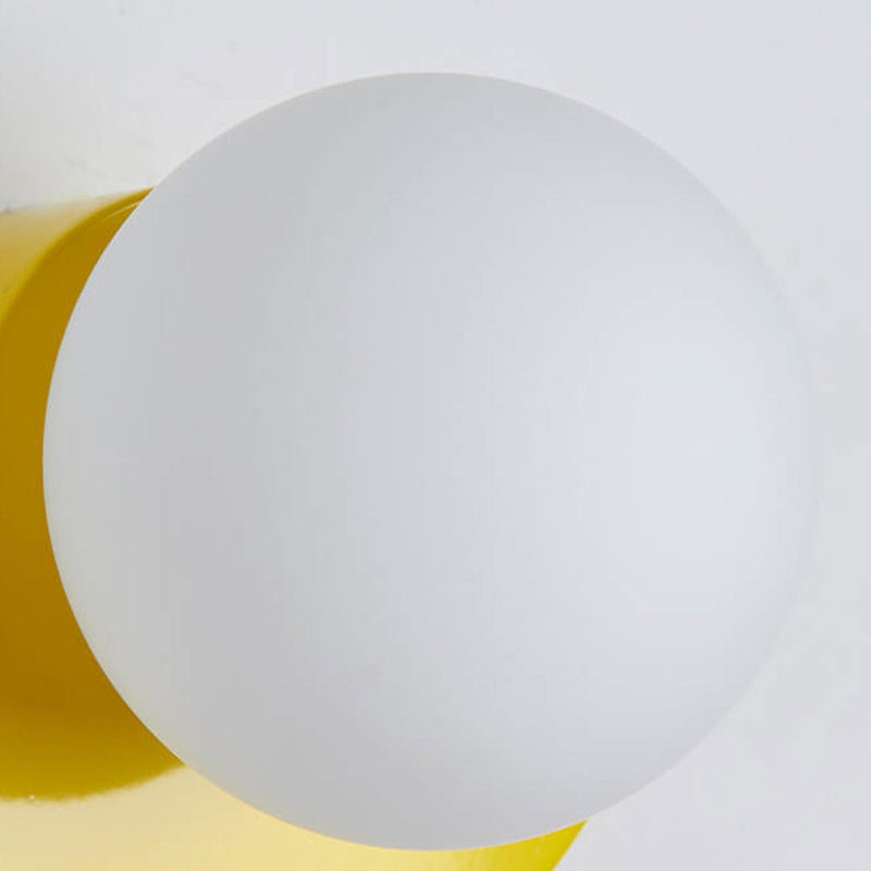 Aurora half moon wall light switched on, warm coloured glow glass wall lamp