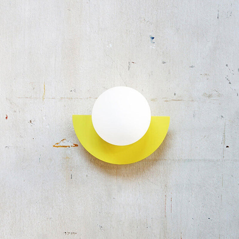 Aurora half moon wall light lit and wall mounted, coloured light design indoor