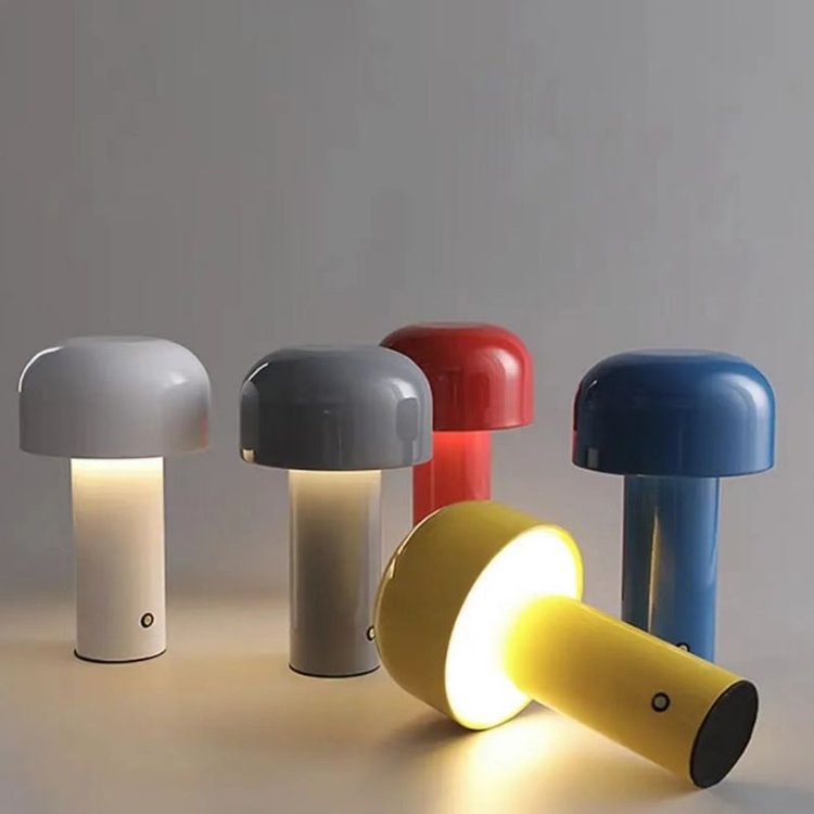 Agari mushroom table lamp glowing warmly on a wooden table, cordless LED ambient light