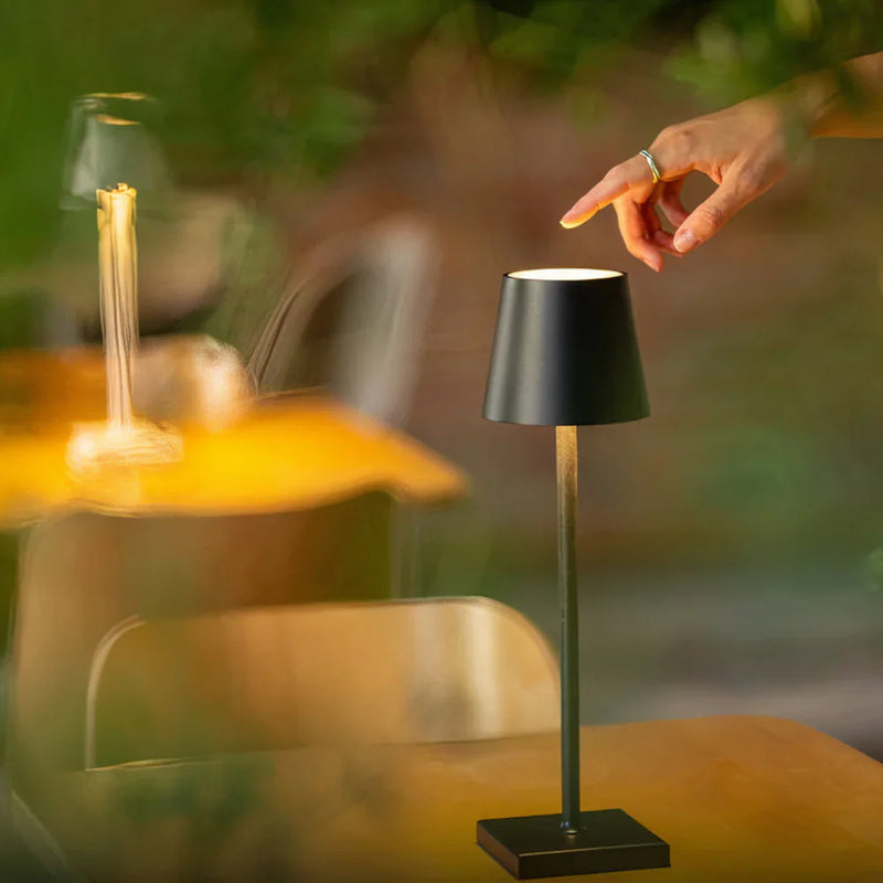 AuraLite Rechargeable Table Lamp illuminating a cosy reading nook with soft diffused glow, nordic design table lamp