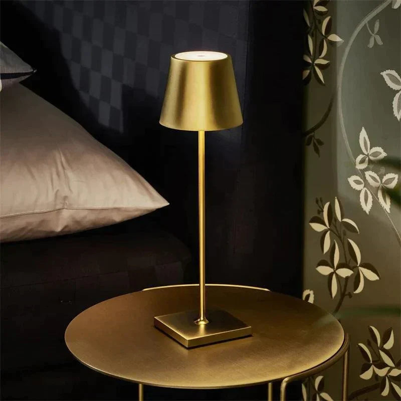 AuraLite Rechargeable Table Lamp glowing warmly in a dimly lit room to create a relaxing atmosphere, scandinavian style desk lamp