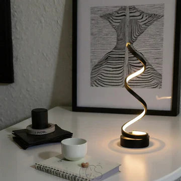 Spiral table lamp side view with emphasised spiral structure and soft warm glow decorative table lamp