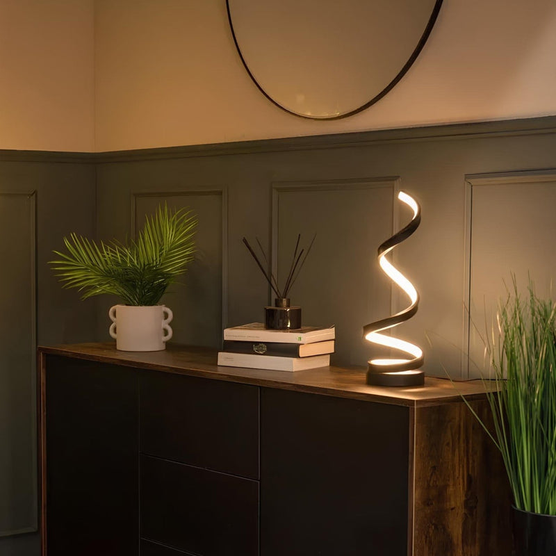 Spiral table lamp detail view of the metal construction with warm incandescent light stylish table lamp