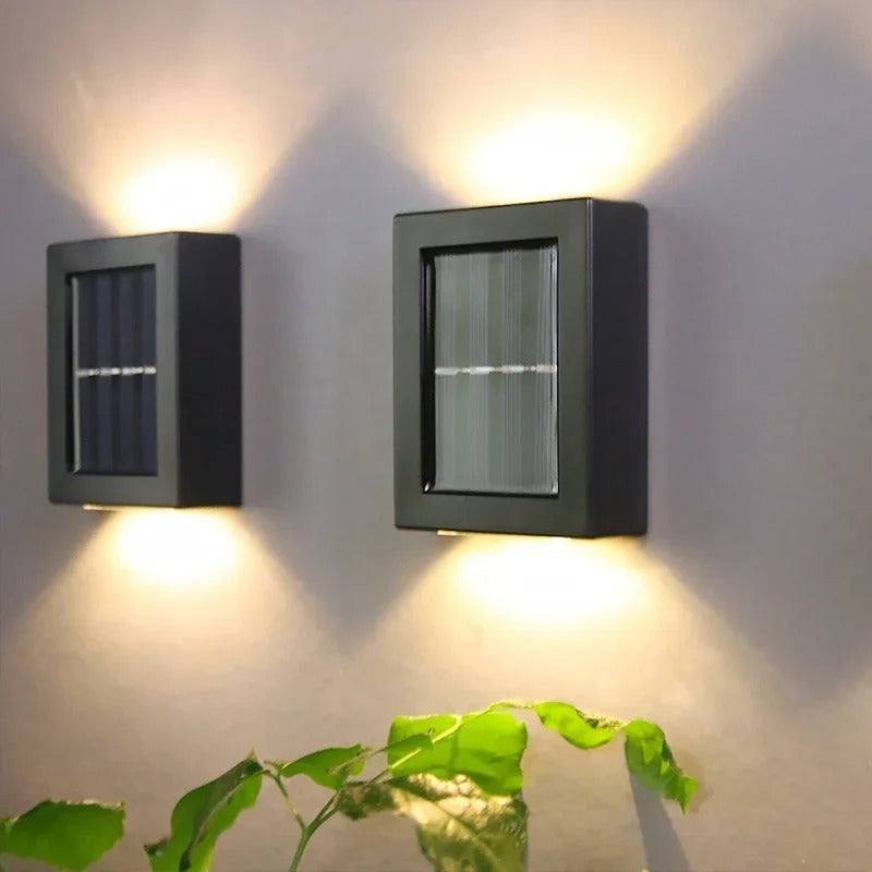 SolarFlare wall light lighting a garden path at night, automatic dusk sensor lamp