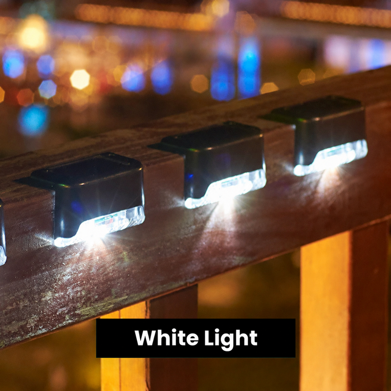 Solar outdoor lights along a wooden fence rail at night, white light setting